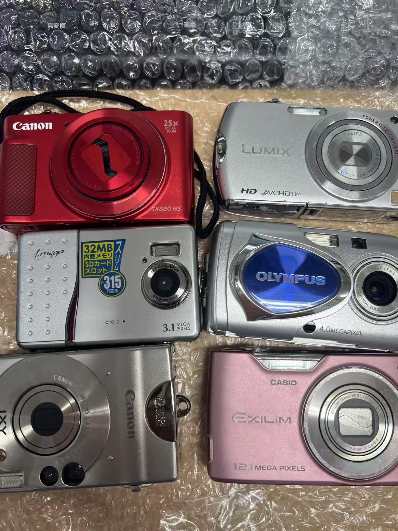 日本代购开箱相机展示,Canon、Olympus、Panasonic和Casio前置镜头细节